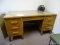 (RM11) WOOD OFFICE DESK WITH 7 DRAWERS AND REMOVEABLE GLASS TOP. MEASURES 60