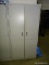 (HALL) CREAM COLORED METAL 2 DOOR CABINET WITH INNER SHELVES. MEASURES 36