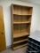 (RM2) WOODGRAIN BOOKCASE WITH 5 ADJUSTABLE SHELVES. SLIGHTLY BOWED. MEASURES 36