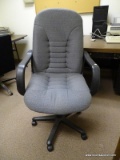 (RM11) GREY UPHOLSTERED ROLLING OFFICE CHAIR. TILTS TO ONE SIDE.