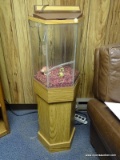 (RM8) HEXAGONAL FISH TANK SET UP. COMES WITH WOOD GRAIN STAND. HAS A LARGE CRACK THAT HAS BEEN