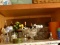 (KIT) TOP SHELF OF CABINET ; LOT INCLUDES- GLASS COMPOTE, BRASS AND COPPER CANDLE HOLDERS, SERVING