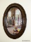 (DBED) PICTURE; FRAMED PRINT IN VINTAGE GRAINED PAINTED OVAL FRAME WITH BUBBLE GLASS- 18 IN X 24 IN