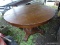 (CARPORT) ANTIQUE TABLE; ANTIQUE ROUND OAK TABLE WITH VENEER TOP AND SCROLL FOOT PEDESTAL BASE,