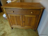 (UPHALL) WASHSTAND; OAK WASHSTAND- 1 DRAWER DOVETAILED WITH MAPLE SECONDARY OVER 2 DOORS- 31 IN X 17