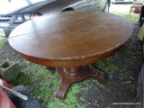 (CARPORT) ANTIQUE TABLE; ANTIQUE ROUND OAK TABLE WITH VENEER TOP AND SCROLL FOOT PEDESTAL BASE,