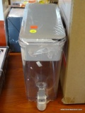 BRITA WATER FILTRATION DISPENSER; IS GRAY WITH A CLEAR BODY AND GRAY SPICKET FOR DISPENSING WATER.
