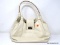 KATE SPADE CREAM COLORED LEATHER SATCHEL BAG WITH GOLD TONE FRONT LATCH. MEASURES APPROX. 13