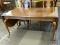 DINING TABLE WITH QUEEN ANNE LEGS. HAS 2 DROP SIDES THAT ROUND OUT TO A END CAP AS WELL AS TWO 20