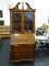 SECRETARY DESK WITH BROKEN ARCH PEDIMENT TOP, CENTER FINIAL, AN UPPER BOOKCASE, FALL FRONT WITH AUTO