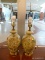 PAIR OF FLORAL PAINTED LAMPS WITH CREAM BASE COLOR. BOTH HAVE HARPS AND FINIALS. MEASURE 33 IN TALL.