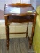 MAHOGANY END TABLE WITH LOWER STORAGE AREA AND GALLERY BACK. MEASURES 18 IN X 14 IN X 31 IN. ITEM IS