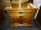 END TABLE WITH 1 UPPER DRAWER OVER 2 DOORS. HAS A BRASS PULL ON THE DRAWER (NEEDS KNOBS ON THE