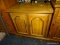 SERVER WITH 2 DOORS THAT OPEN TO REVEAL AN INTERIOR SHELF. MEASURES 30 IN X 18 IN X 31.5 IN. HAS A