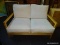 MAPLE AND WHITE UPHOLSTERED CUSHION FUTON. MEASURES 50 IN X 32 IN X 32 IN. SOLD AS IS, WHERE IS,