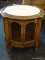 ROUND MARBLE TOP END TABLE WITH 2 LATTICE PATTERN DOORS. MEASURES 26 IN X 24 IN. SOLD AS IS, WHERE