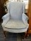 MAHOGANY QUEEN ANNE WING CHAIR WITH ROLLED ARMS, BLUE UPHOLSTERY, AND A BUTTON TUFTED SEAT. MEASURES