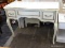 CREAM COLORED VANITY WITH 2 DRAWERS, A LIFT-TOP CENTER WITH MIRROED BACK AND INTERIOR STORAGE, AND