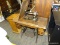 ANTIQUE SINGER SEWING MACHINE IN OAK CASE WITH CAST IRON BASE. HAS A STENCILED PATTERN AND IS BLACK