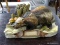NATURECRAFT LTD. HAND PAINTED FIGURINE OF A WOLVERINE. MEASURES 9.5 IN X 5.5 IN X 4 IN. ITEM IS SOLD