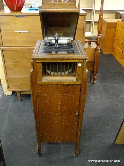 EDISON OAK MUSIC CABINET WITH LIFT TOP, CENTER HORN, AND 1 LOWER DOOR THAT OPENS TO REVEAL STORAGE.