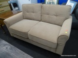 MODERN TAN COLORED LOVESEAT WITH ATTACHED SEATS AND ROLLED ARMS. MEASURES 55 IN X 29 IN X 32 IN.