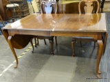 DINING TABLE WITH QUEEN ANNE LEGS. HAS 2 DROP SIDES THAT ROUND OUT TO A END CAP AS WELL AS TWO 20