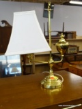 BRASS LAMP WITH HANDLE, SQUARE CLOTH SHADE, AND HOOP STYLE FINIAL ON THE HANDLE. MEASURES 12.5 IN X