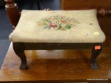 FOOTSTOOL WITH FLORAL UPHOLSTERED TOP. MEASURES 14 IN X 9 IN X 8 IN. ITEM IS SOLD AS IS WHERE IS