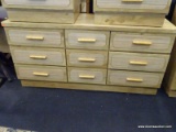 9 DRAWER LIGHT WOOD DRESSER WITH BAMBOO STYLE HANDLES. MEASURES 60 IN X 18 IN X 29 IN. ITEM IS SOLD
