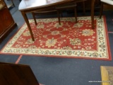 SABRY AREA RUG IN RED AND CREAM. MEASURES 4 FT 11 IN X 7 FT 4 IN. SOLD AS IS, WHERE IS, WITH NO