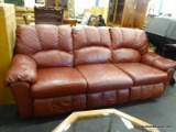 OX BLOOD RED LEATHER DOUBLE RECLINER WITH OVERSTUFFED CUSHIONS. MEASURES 93 IN X 34 IN X 34 IN. ITEM