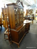 CHINA CABINET WITH BROKEN ARCH PEDIMENT TOP, CENTER FINIAL, 2 INTERIOR SHELVES, A CENTER DRAWER, AND