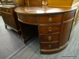 MAHOGANY DEMILUNE DESK WITH 4 SIDE DRAWERS ON EITHER SIDE AND A CENTER DRAWER. MEASURES 45 IN X 23