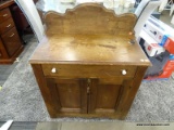 ANTIQUE WASHSTAND WITH 1 DRAWER OVER 2 DOORS. MEASURES 29 IN X 15 IN X 28 IN. HAS SOME BACKBOARDS