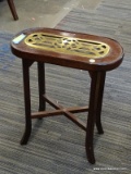 END TABLE WITH BRASS INSERT IN THE TOP. HAS A CROSS-STRETCHER BASE AND MEASURES 9.5 IN X 17.5 IN X