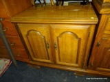 SERVER WITH 2 DOORS THAT OPEN TO REVEAL AN INTERIOR SHELF. MEASURES 30 IN X 18 IN X 31.5 IN. HAS A