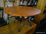 ROUND COFFEE TABLE WITH IRON BASE. MEASURES 32 IN X 20 IN. SOLD AS IS, WHERE IS, WITH NO GUARANTEE