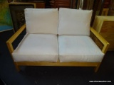 MAPLE AND WHITE UPHOLSTERED CUSHION FUTON. MEASURES 50 IN X 32 IN X 32 IN. SOLD AS IS, WHERE IS,