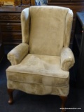 MAHOGANY QUEEN ANNE WING CHAIR WITH ROLLED ARMS AND TAN UPHOLSTERY. MEASURES 30 IN X 30 IN X 41 IN.