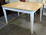 WHITE AND MAPLE DINETTE TABLE WITH TAPERED LEGS. MEASURES 38 IN X 52 IN X 30 IN. SOLD AS IS, WHERE