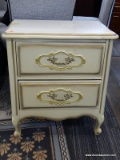 CREAM COLORED 2 DRAWER NIGHT STAND WITH GOLD TONED ACCENTS. MEASURES 21 IN X 16 IN X 24 IN. SOLD AS