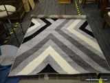 CLAREMONT COLLECTION AREA RUG IN BLACK AND GRAY. MEASURES 5 FT X 7 FT 6 IN. SOLD AS IS, WHERE IS,