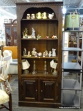 PINE SHELVING UNIT WITH 4 SHELVES AND 2 LOWER DOORS WITH WOODEN PANELED FRONTS. HAS A DENTIL MOLDING