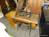 ANTIQUE SINGER SEWING MACHINE IN OAK CASE WITH CAST IRON BASE. HAS A STENCILED PATTERN AND IS BLACK