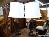 PAIR OF URN STYLE LAMPS WITH WHITE CLOTH SHADES AND BLACK FINISH. EACH LAMP MEASURES 24 IN TALL.