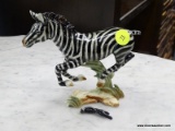 GOEBEL FIGURINE OF A ZEBRA. #36 302. MEASURES 6 IN X 2 IN X 5.5 IN. TAIL NEEDS REPAIR. ITEM IS SOLD