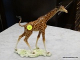 GOEBEL FIGURINE OF A GIRAFFE. #36 307 19. MEASURES 8 IN X 2.5 IN X 8.5 IN. ITEM IS SOLD AS IS WHERE