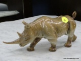 GOEBEL FIGURINE OF A RHINO. #308. MEASURES 9 IN X 3 IN X 3.5 IN. EAR HAS A CHIP. ITEM IS SOLD AS IS