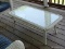 (BCK PRCH) WHITE WICKER COFFEE TABLE WITH GLASS PROTECTIVE TOP. MEASURES 43 IN X 22 IN X 16 IN. ITEM